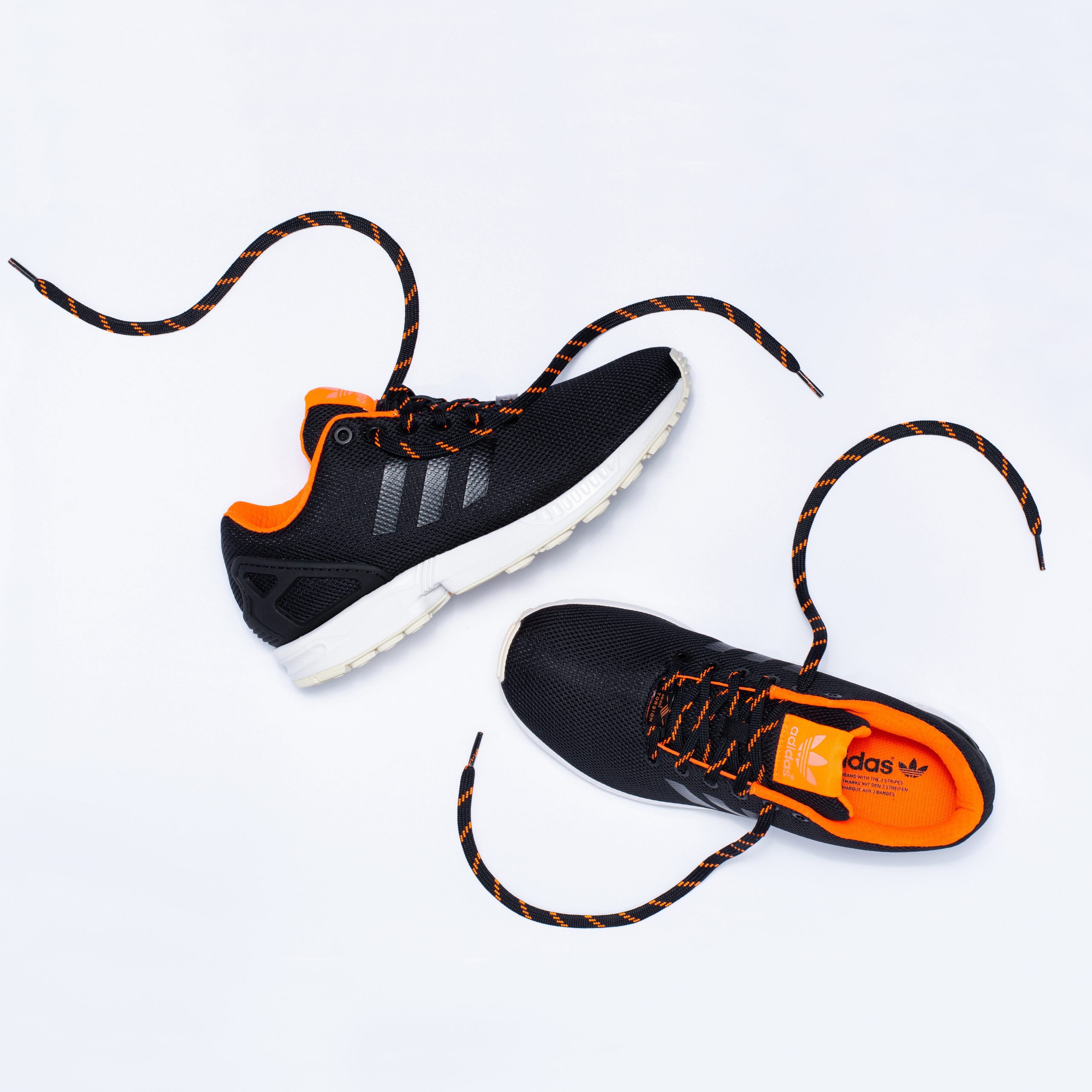 Adidas ZX Flux trainers shown from above with laces undone