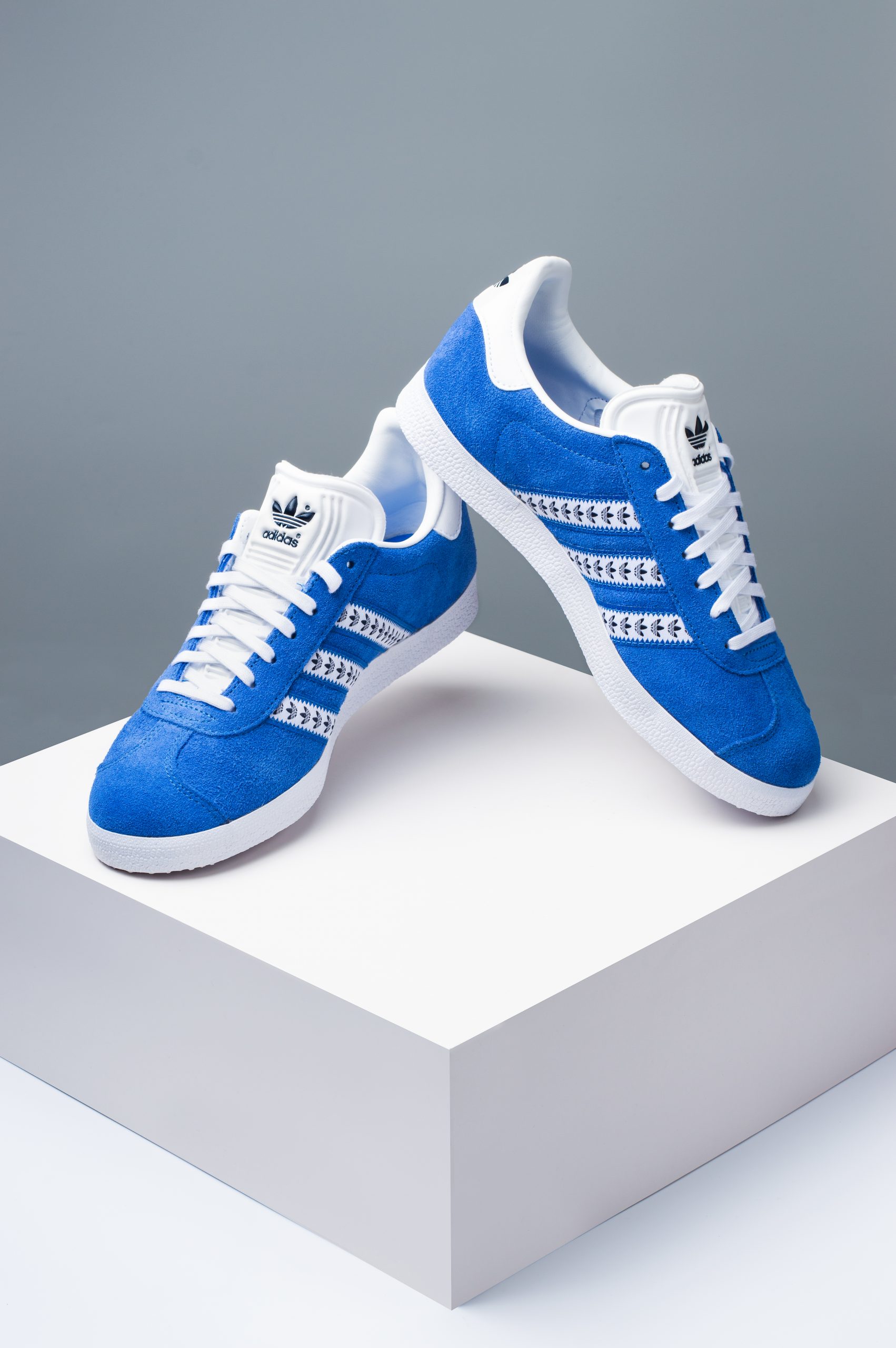 Adidas Gazelle blue suede trainers shown as a pair from angled side view