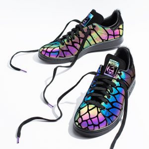Pair of trainers with iridescent rainbow holographic finish, product photography