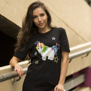 Woman wearing black t-shirt with colourful unicorn and stars print, outdoor setting
