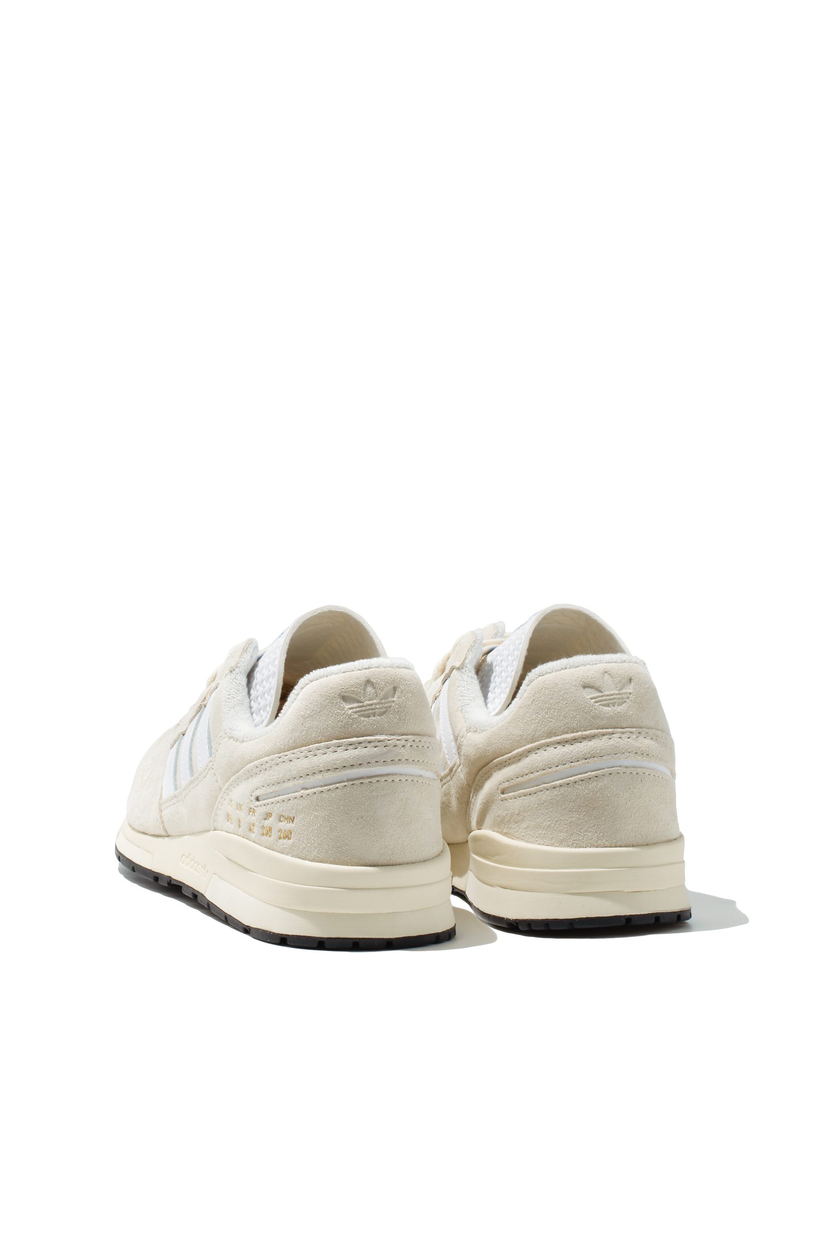 Pair of Adidas ZX 420 trainers in cream suede from angled side view