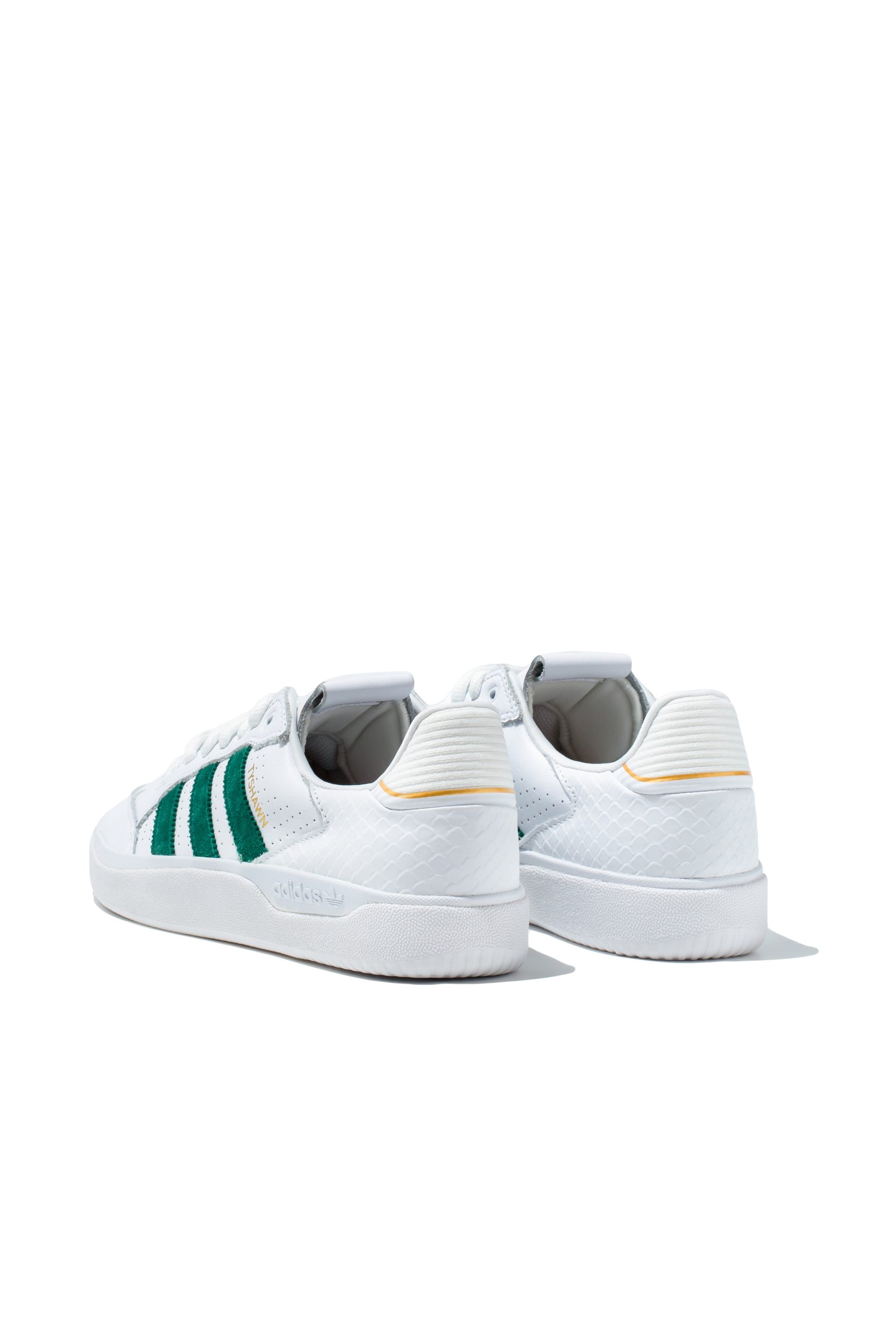 Adidas Stan Smith trainers in white with green details from rear angle