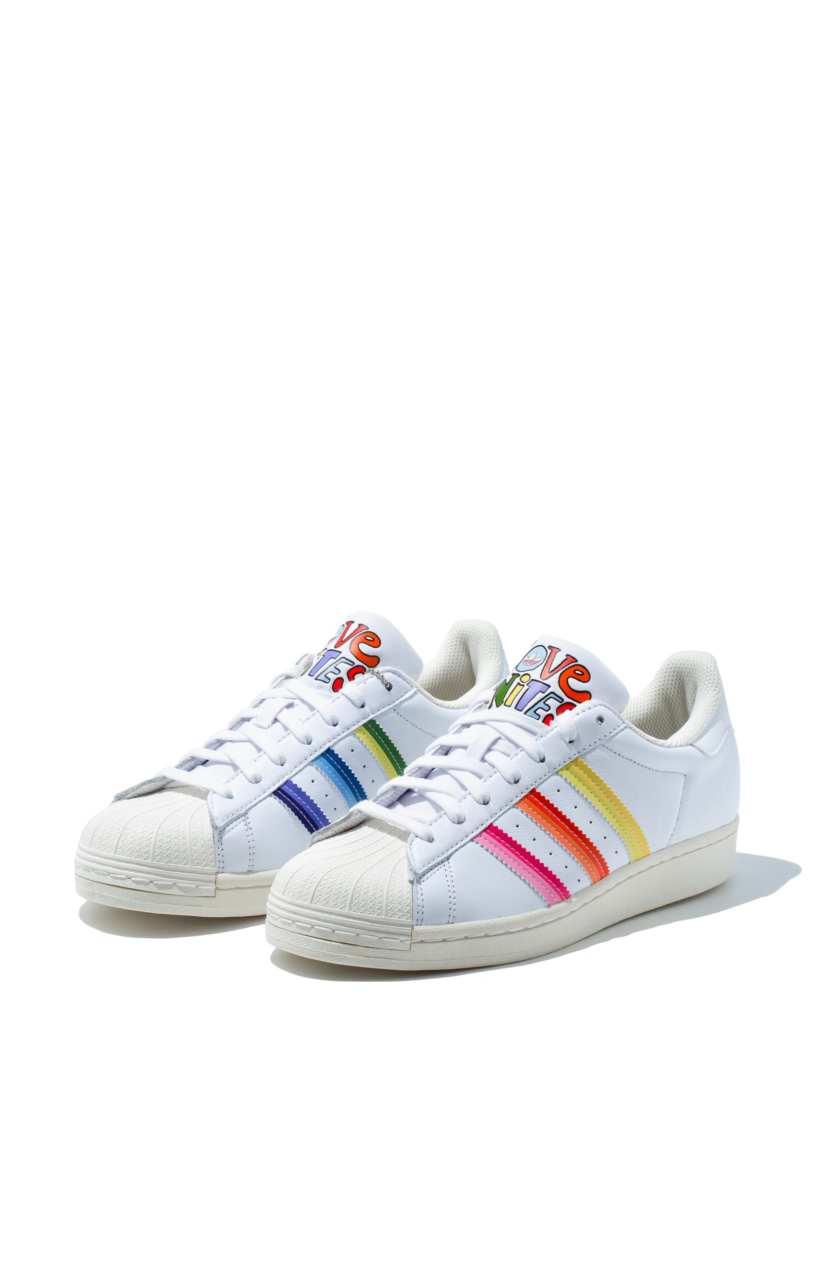 Adidas Superstar Pride trainers in white with rainbow three-stripe detail, front view