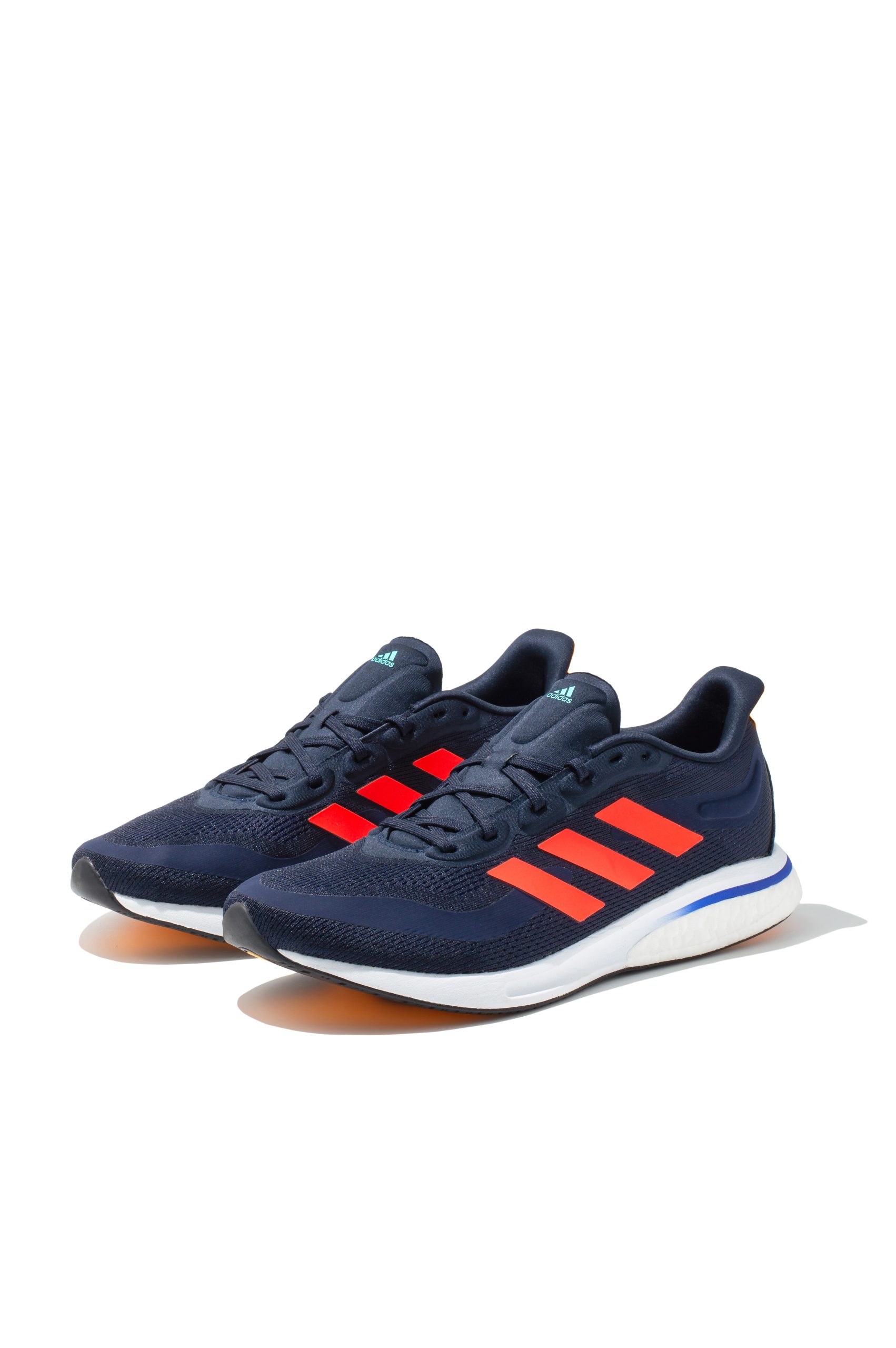 Adidas Supernova running trainers in navy and orange viewed head-on