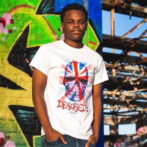 Man wearing Deadhedz Union Jackz skull t-shirt against graffiti wall